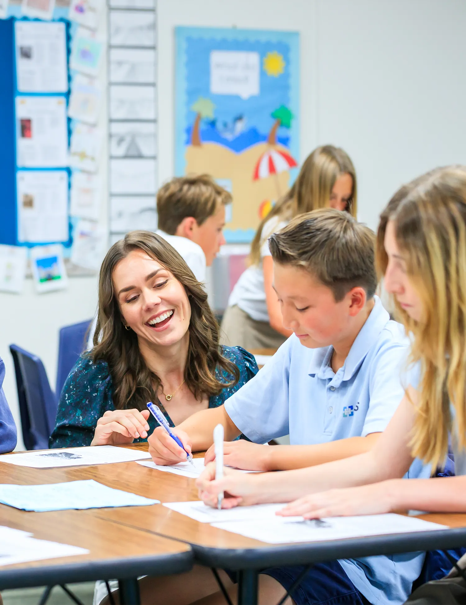 Teacher in a Classroom helping a student
